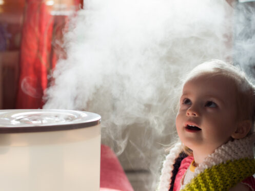Childing looking at humidifier
